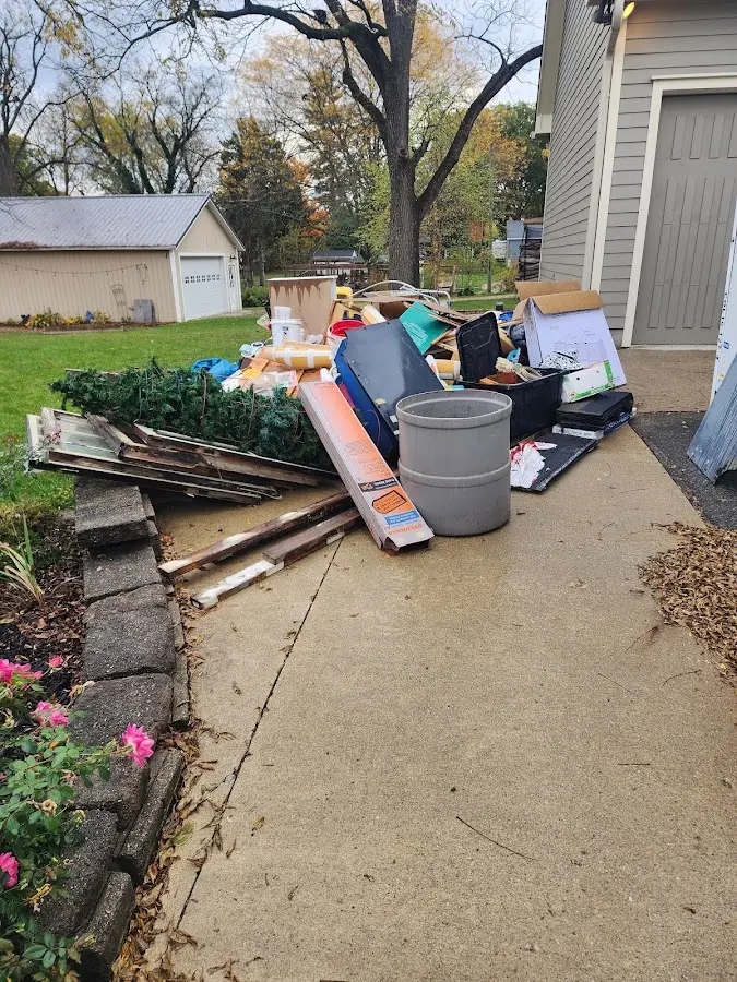 Dumpster being loaded with debris for 12 Yard Dumpster Rental in Keyes